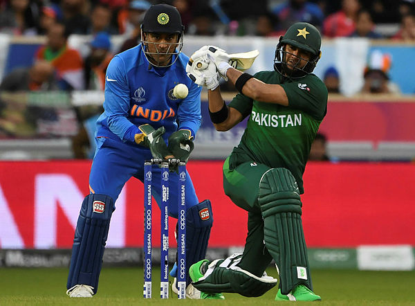 Pakistan’s Rahat Ali (right) plays a shot watched by India’s Mahendra Singh Dhoni (left) during the 2019 Cricket World Cup group stage match between India and Pakistan at Old Trafford in Manchester, England, on June 16, 2019.