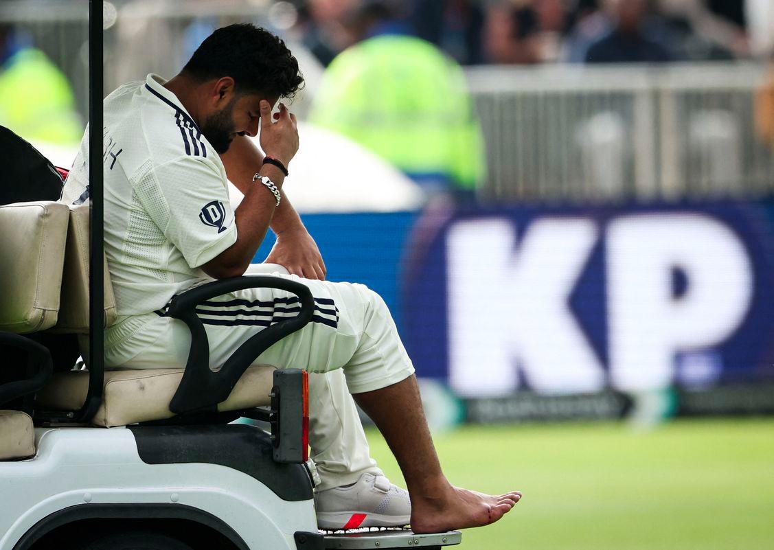 India's Rishabh Pant reacts as he driven on a buggy out of the pitch following a foot injury while playing on day one of the fourth cricket test match between England and India at Old Trafford, in Manchester, north England, on July 23, 2025. - AFPPIX