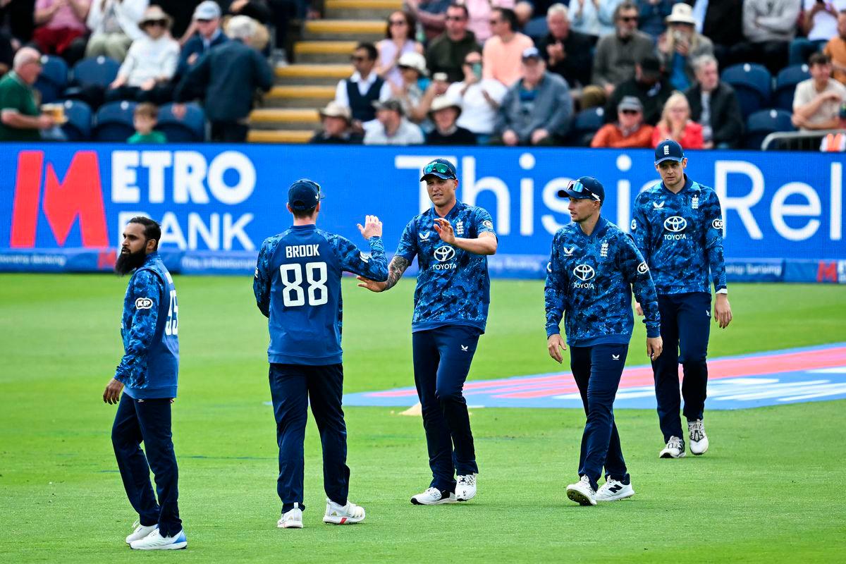 England’s Harry Brook (2nd) congratulates England’s Brydon Carse (C) after taking the wicket of West Indies’ Brandon King (unseen) during the second One Day International (ODI) cricket match between England and West Indies at Sophia Gardens cricket ground in Cardiff on June 1, 2025. (Photo by Paul ELLIS / AFP)