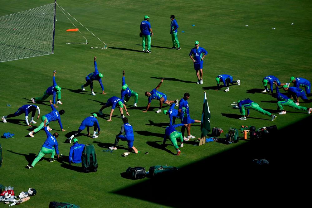Pakistan’s cricketers warm up before the team practice session at the National Stadium in Karachi on December 15, 2022, ahead of the third cricket Test match between Pakistan and England. AFPPIX