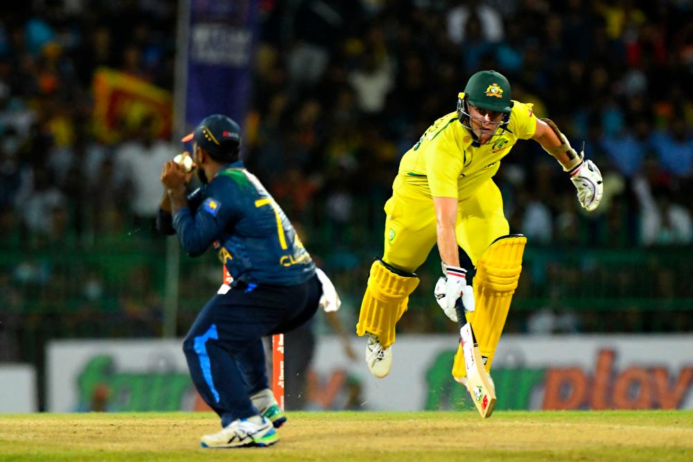 Australia’s Jhye Richardson (R) runs to save his wicket during the second Twenty20 international cricket match between Sri Lanka and Australia at the R. Premadasa International Cricket Stadium in Colombo on June 8, 2022. AFPPIX