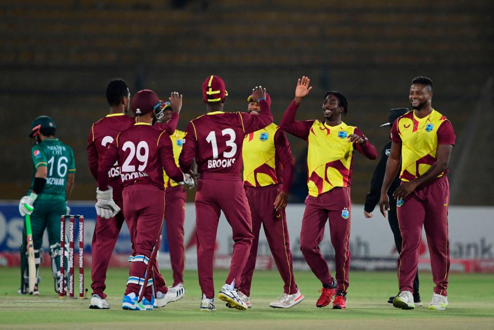 West Indies' cricketers celebrate the wicket of Pakistan cricket captain Babar Azam (not pictured) during the second Twenty20 international cricket match between Pakistan and West Indies at the National Stadium in Karachi on December 14, 2021. AFPpix