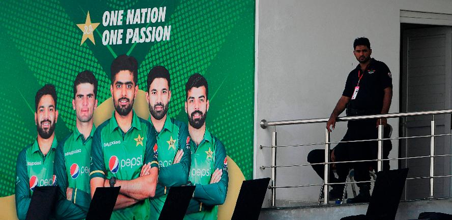 A policeman stands guard next to a poster featuring Pakistan’s cricket players at the Rawalpindi Cricket Stadium. – AFPPIX