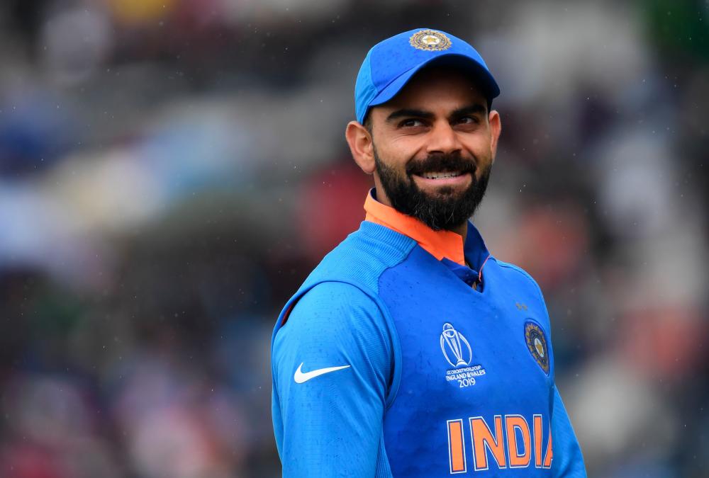 India's captain Virat Kohli looks on as rain falls during the 2019 Cricket World Cup group stage match between India and Pakistan at Old Trafford in Manchester, northwest England, on June 16, 2019. — AFP