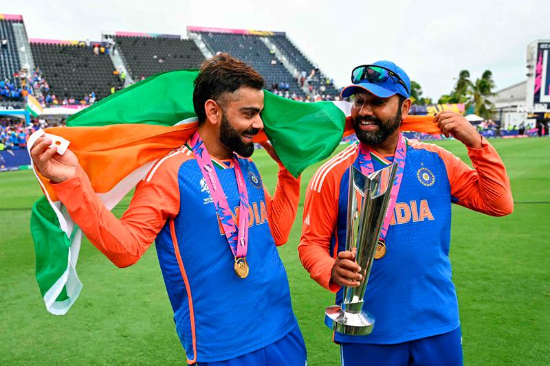 India's Virat Kohli (L) and captain Rohit Sharma celebrate with the trophy after winning the ICC men's Twenty20 World Cup 2024 final cricket match between India and South Africa at Kensington Oval in Bridgetown, Barbados, on June 29, 2024. - AFPpix
