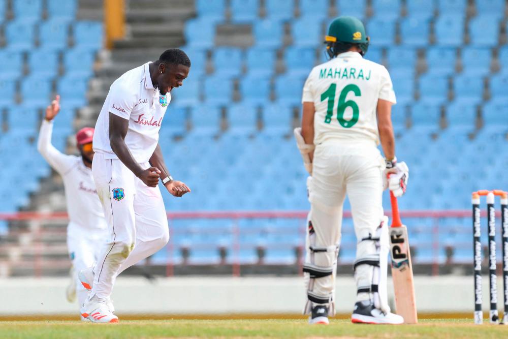 Jayden Seales (left) of West Indies celebrates the dismissal of Keshav Maharaj (right) of South Africa during day 3 of the 2nd Test between South Africa and West Indies at Darren Sammy Cricket Ground, Gros Islet, Saint Lucia. – AFPPIX