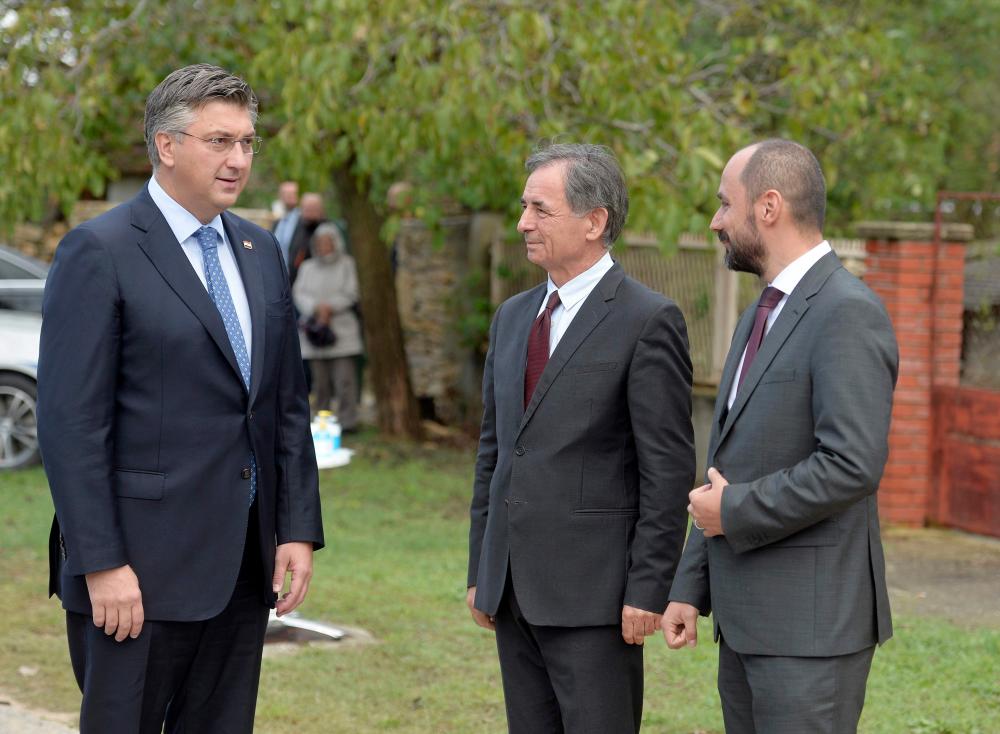 Croatian Prime Minister Andrej Plenkovic (Left), President of the Serbian People’s Party Milorad Pupovac (Centre), and Deputy Prime Minister of Croatia in charge of social affairs and human and minority rights Boris Milosevic (Right) attend a ceremony to in commemoration of ethnic Serb civilians killed in the aftermath of the country’s 1990s independence war in Varivode on Sept 28, 2020. — AFP