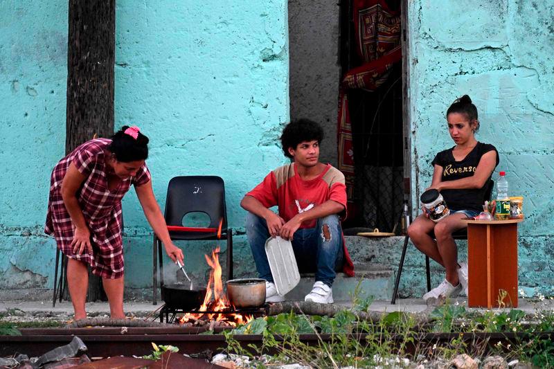 Cubans cook outside their home during a nationwide blackout caused by a power grid failure in Havana on March 15, 2025. AFPpix