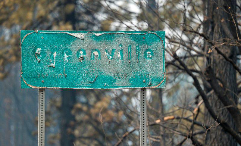 The sign leading to Greenville is pictured with letters that melted off when the Dixie Fire burned through the town, in Greenville, California, U.S. August 8, 2021. -Reuters