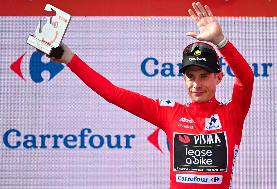 The overall leader Team Visma-Lease a bike's Danish rider Jonas Vingegaard celebrates on the podium wearing the red jersey after the tenth stage of the Vuelta a Espana cycling tour, a 168 km race between Sendaviva Natural Park in Arguedas and El Ferial Larra Belagua in Isaba, on September 2, 2025. - AFPPIX