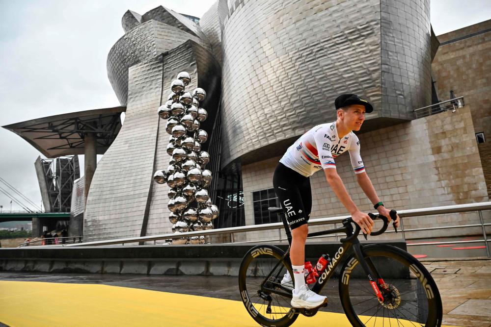 UAE Team Emirates’ Slovenian rider Tadej Pogacar cycles to the stage during the official teams presentation near the Guggenheim Museum Bilbao, in Bilbao, northern Spain, on June 29, 2023, two days prior to the start of the 110th edition of the Tour de France cycling race/AFPPix