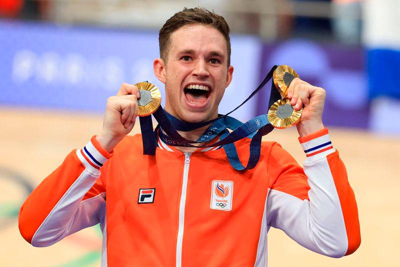 Netherlands’ Harrie Lavreysen celebrates his gold medal victory, with his total of three gold medals, on the podium after winning the men’s track cycling keirin event - AFPpix