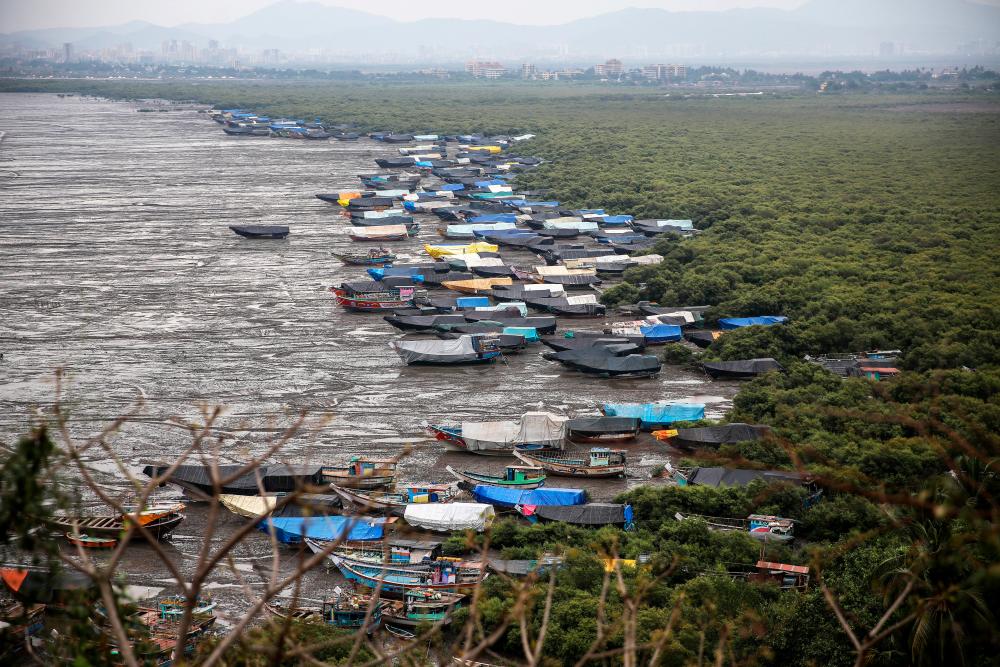 General view of Indian fishing boats covered with tarpaulins anchoring at the shore of the Arabian sea near Chowk Dongri at the village of Uttan, near Mumbai, India, June 2, 2020. - EPA