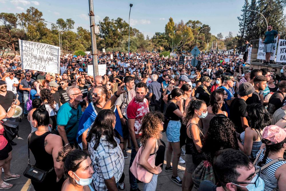 People gather for a demonstration outside the presidential palace in Cyprus’ capital Nicosia on July 18, 2021, in protest against new Covid-19 coronavirus pandemic safety measures introduced by the government amidst a recent rise in infection figures.-AFP