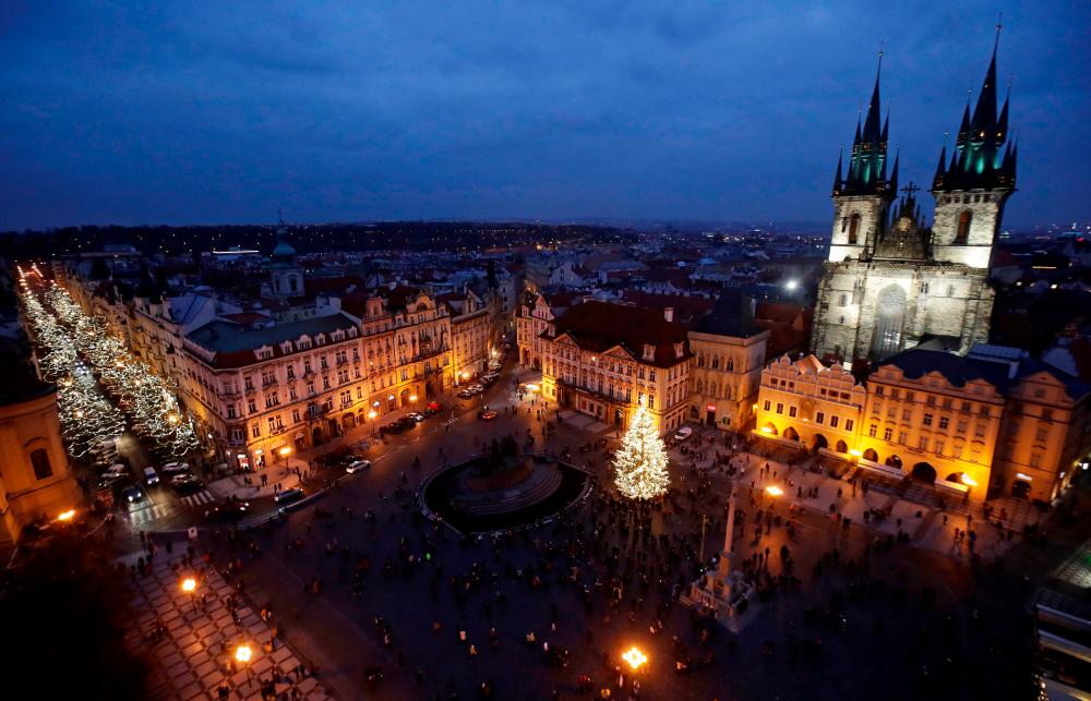 A Christmas tree is illuminated as the traditional Christmas market has been cancelled at the Old Town Square in Prague due to Covid-19 concerns, Czech Republic, November 28, 2020. — Reuters