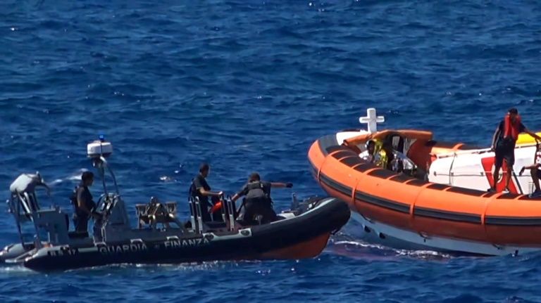 Migrants are rescued after throwing themselves in the sea off Italy’s Lampedusa island in a desperate bid to swim ashore. — AFP