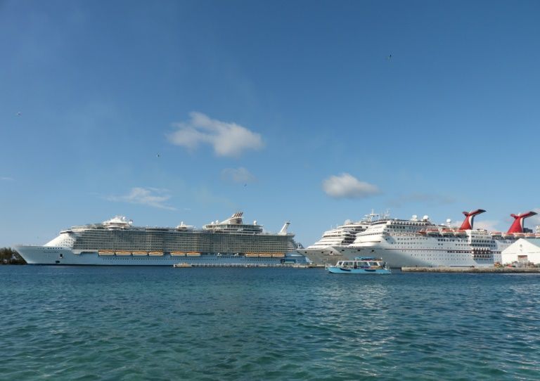The Royal Caribbean ship Allure of the Seas (L) and Carnival Cruise ships Liberty and Elation are seen in Nassau, Bahamas in April 2019. — AFP