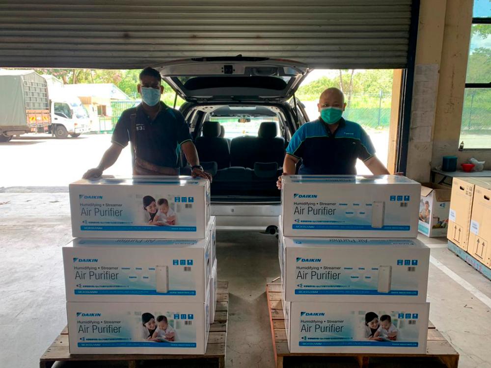 Daikin employees delivering the air purifiers.
