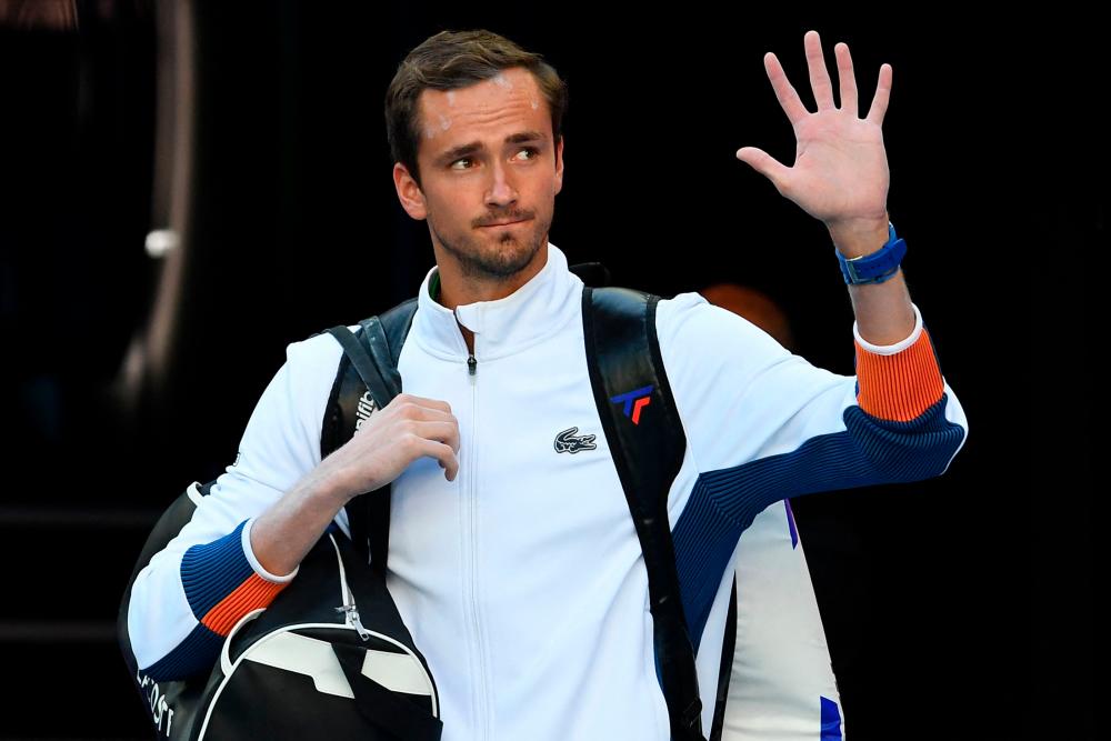 Russia's Daniil Medvedev waves as he arrives to play against Australia's Nick Kyrgios in their men's singles match on day four of the Australian Open tennis tournament in Melbourne on January 20, 2022. AFPpix