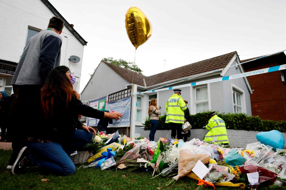 Well-wishers lay floral tributes at the scene of the fatal stabbing of Conservative British lawmaker David Amess, at Belfairs Methodist Church in Leigh-on-Sea, a district of Southend-on-Sea, in southeast England on October 16, 2021. AFPpix