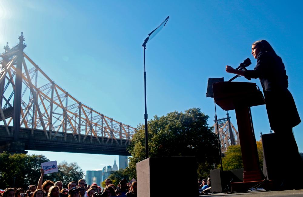 US Rep. Alexandria Ocasio-Cortez (D-NY) speaks at a ‘Bernie's Back’ rally for Democratic 2020 US presidential candidate and US Senator Bernie Sanders (I-VT) at Queensbridge Park in the Queens Borough of New York City, US, October 19, 2019. - Reuters