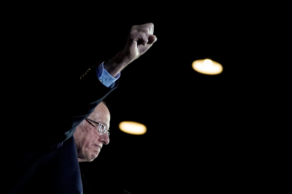 Democratic presidential candidate Sen. Bernie Sanders (I-VT) raises his fist as he arrives onstage after winning the Nevada caucuses during a campaign rally at Cowboys Dancehall on February 22, 2020 in San Antonio, Texas. - AFP