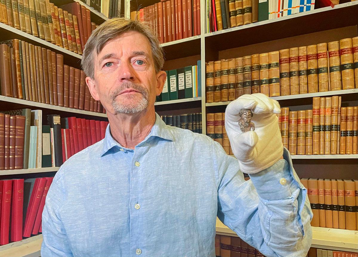 Denmark’s national museum curator Peter Pentz shows a gaming piece which is believed to be the first portrait of a Viking, on August 26, 2025 in Copenhagen. - Camille BAS-WOHLERT / AFP