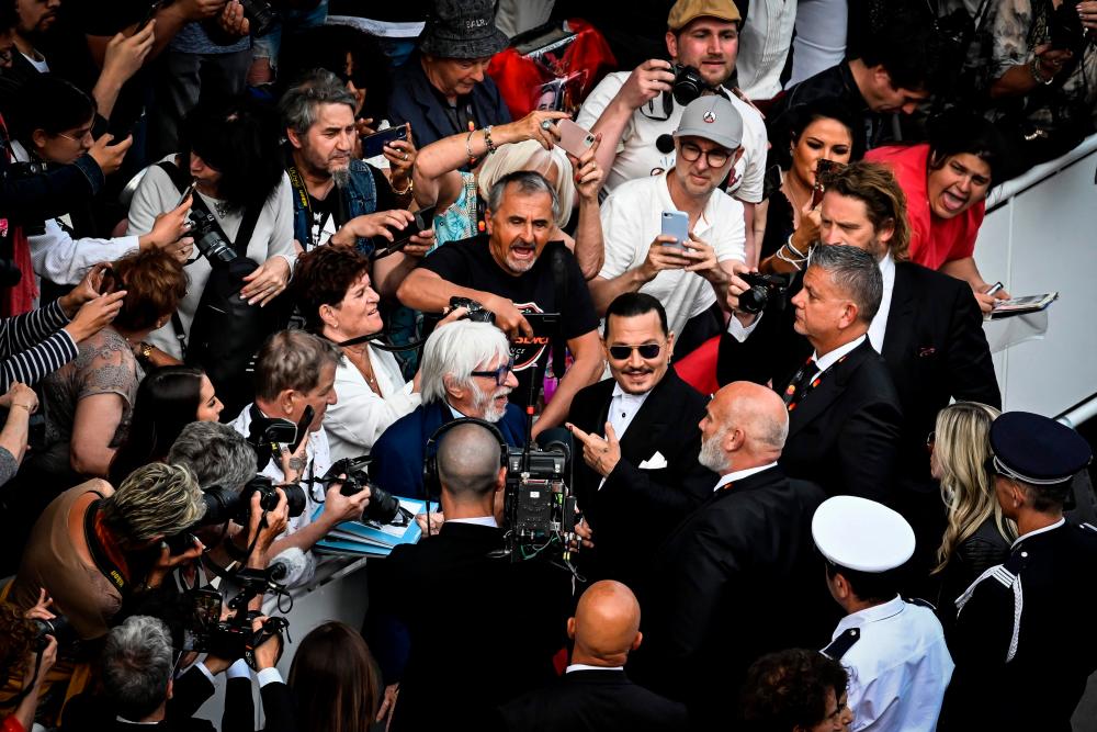 Johnny Depp received a heroes’ welcome on the Cannes red carpet. – AFP