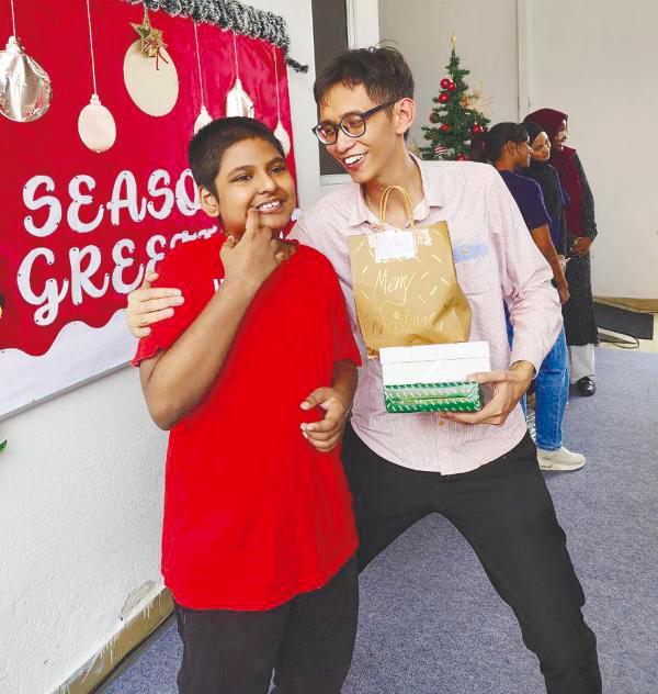 $!Teacher Dickson Yu hugs pupil Md Faiyazur Rahman Fardin before presenting him with prizes.