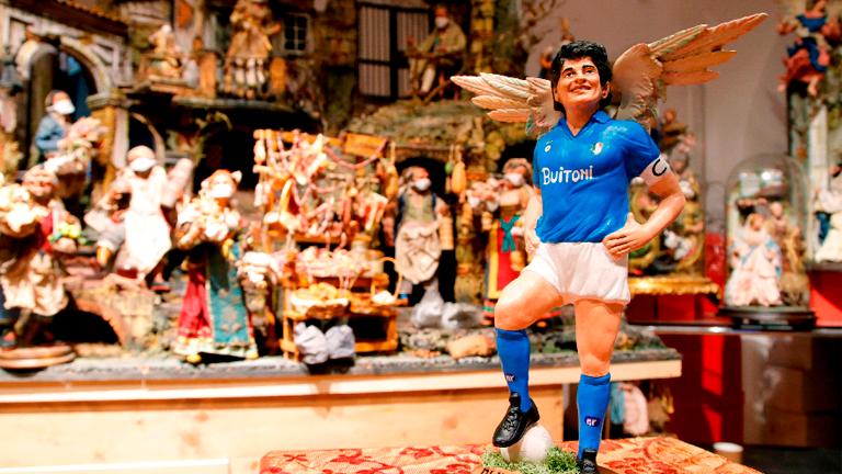 A figurine depicting late football legend Diego Maradona with angel wings is pictured the day after his death at a shop on Via San Gregorio Armeno, the famous street in Naples dedicated to producing nativity figurines on Nov 26, 2020. – REUTERSPIX