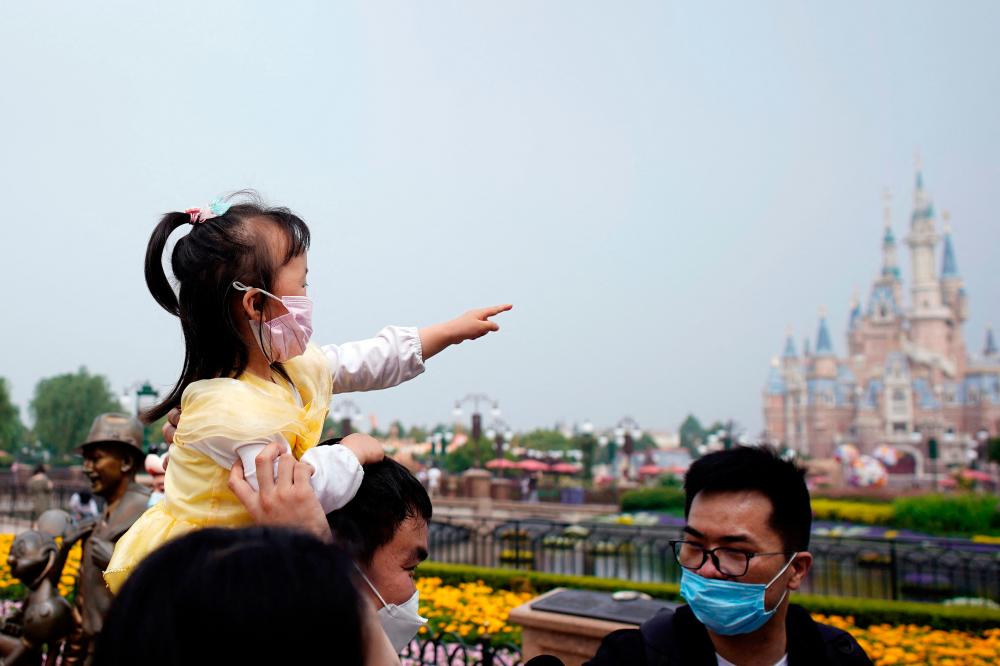 File photo: Visitors wearing face masks are seen at the Shanghai Disneyland theme park as it reopens following a shutdown due to the coronavirus disease (Covid-19) outbreak, at Shanghai Disney Resort in Shanghai, China May 11, 2020. REUTERSpix
