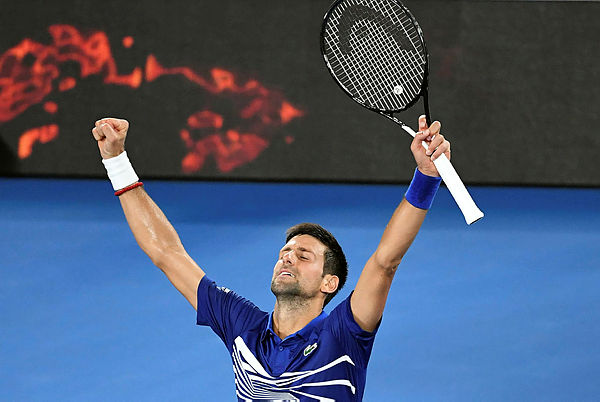 Serbia’s Novak Djokovic celebrates his victory against Russia’s Daniil Medvedev during their men’s singles match on day eight of the Australian Open — AFP