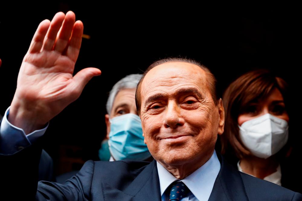 Italy’s former Prime Minister Silvio Berlusconi waves as he arrives at Montecitorio Palace for talks on forming a new government, in Rome, Italy, February 9, 2021. — Reuters