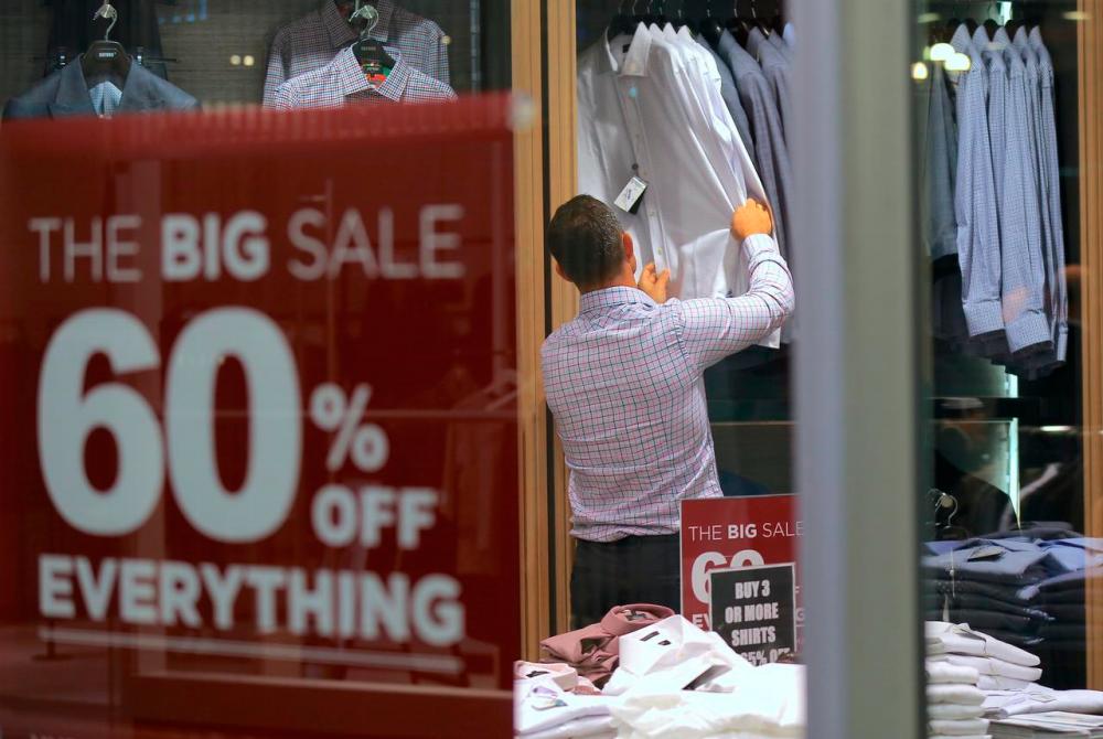 A customer looks at shirts on sale in a retail store in central Sydney, Australia. REUTERSPIX