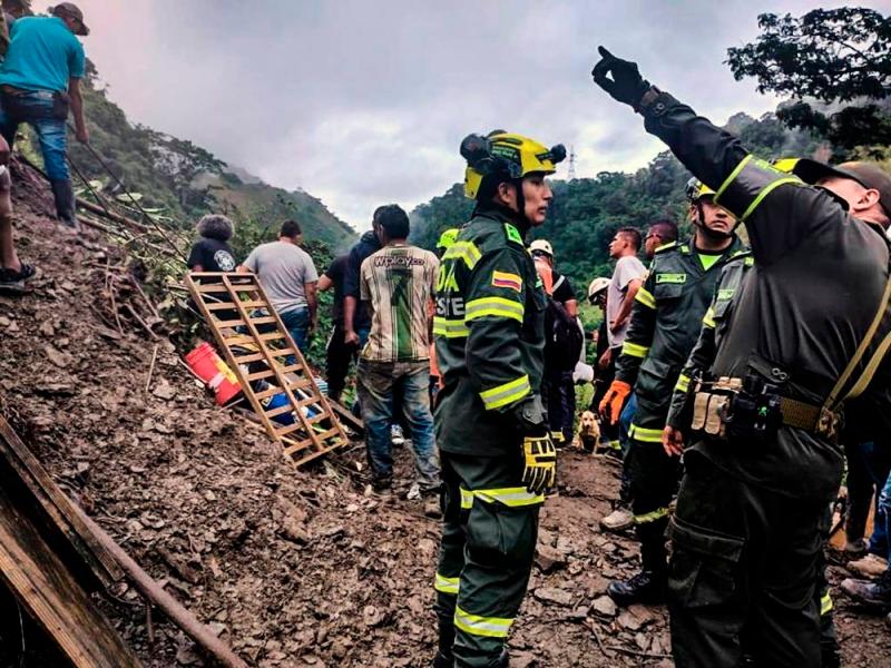Handout picture released by Colombia’s National Police press office showing rescuers woring in the site of a landslide in the sector El Ruso, Pueblo Rico municipality, in northwestern Bogota, Colombia, on December 4, 2022. — Colombia’s National Police Press Office handout via AFP