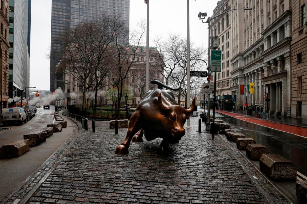 The Wall St. Bull is seen standing on a nearly empty Broadway in the financial district, as the coronavirus disease outbreak continues, in New York City, New York, US. REUTERSPIX
