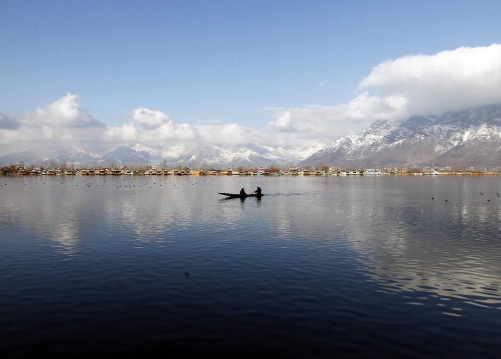 Filepix taken on Feb 4, 2015 shows a man rowing a small boat on the waters of Dal Lake on a sunny day in Srinagar. — Reuters