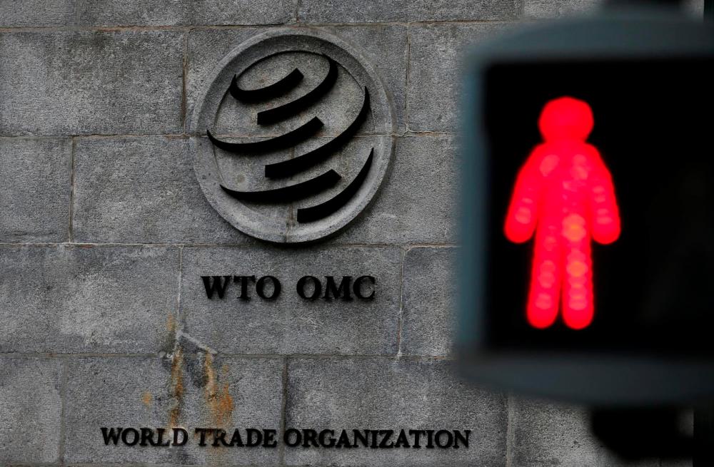 File photo shows a red light pictured at a pedestrian crossing in front of the World Trade Organization headquarters in Geneva, Switzerland, Dec 9. — Reuters