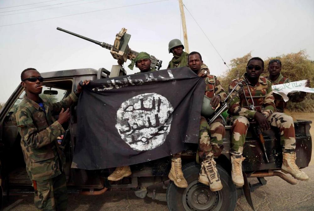 Filepix showing Nigerian soldiers holding up a Boko Haram flag that they had seized in the recently retaken town of Damasak, Nigeria, Mar 18, 2015