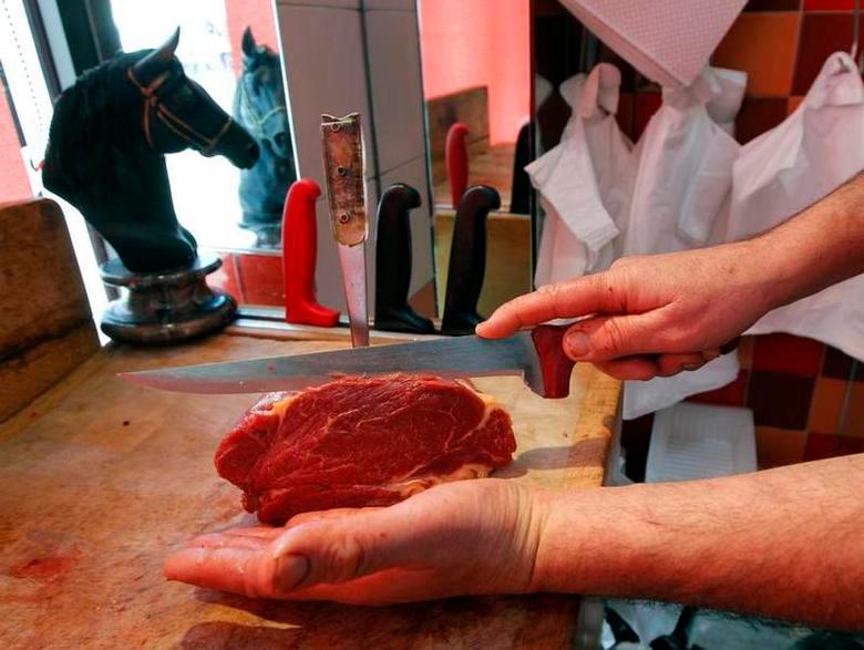 A French butcher cuts a piece of horsemeat on a block in a horse butchery shop in Marseille February 14, 2013. REUTERSPIX