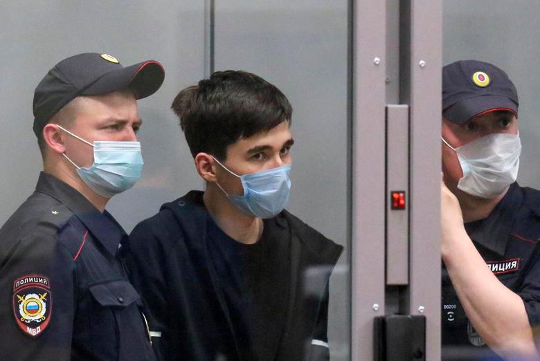 Ilnaz Galyaviev, a suspect in deadly school shooting at School Number 175, and police officers stand inside a defendants’ cage before a court hearing in Kazan, Russia May 12, 2021. REUTERSPIX