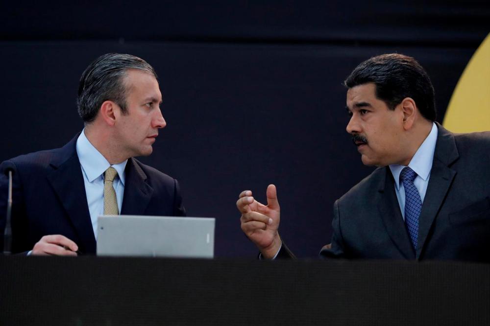 Venezuela’s President Nicolas Maduro (R) speaks with Venezuela’s Vice President Tareck El Aissami as they attend the event launching the new Venezuelan cryptocurrency “petro” in Caracas, Venezuela Feb 20, 2018. — Reuters