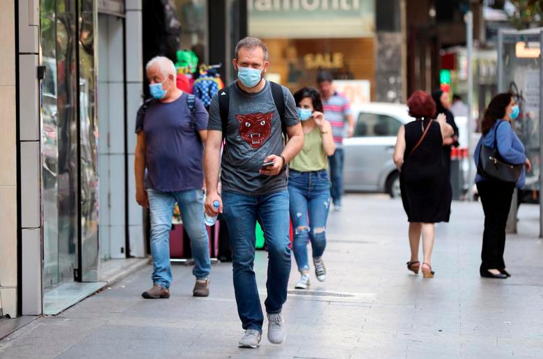 FILE PHOTO: People walk as they wear face masks to prevent the spread of the coronavirus disease (Covid-19) in Beirut, Lebanon July 28, 2020. REUTERSpix