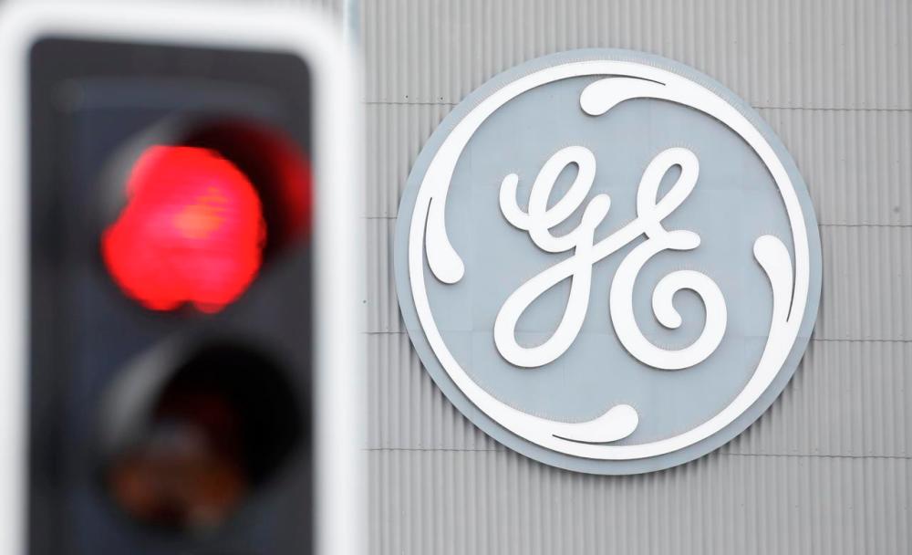 A traffic light is seen in front of a logo of General Electric at the company’s plant in Birr, Switzerland. REUTERSPIX