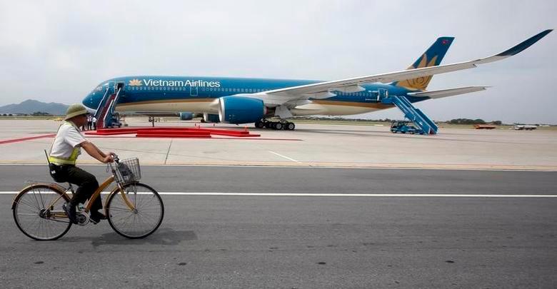 A security guard cycles near an Airbus A350-900 aircraft during its delivery ceremony at Noi Bai International Airport in Hanoi July 2, 2015. REUTERSPIX