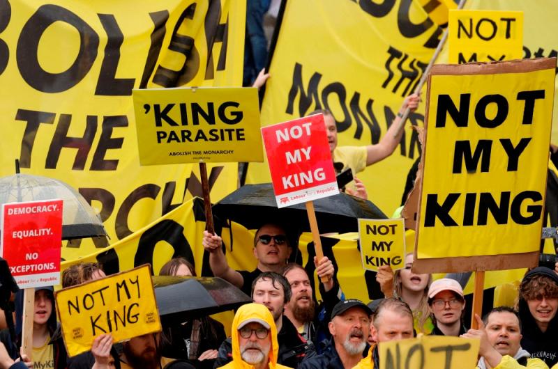 Hundreds of yellow-clad demonstrators gathered among the 10-deep crowds lining the procession route in central London to stand out from those clad in red, white and blue, and to hold up signs saying ‘Not My King’//Reuterspix