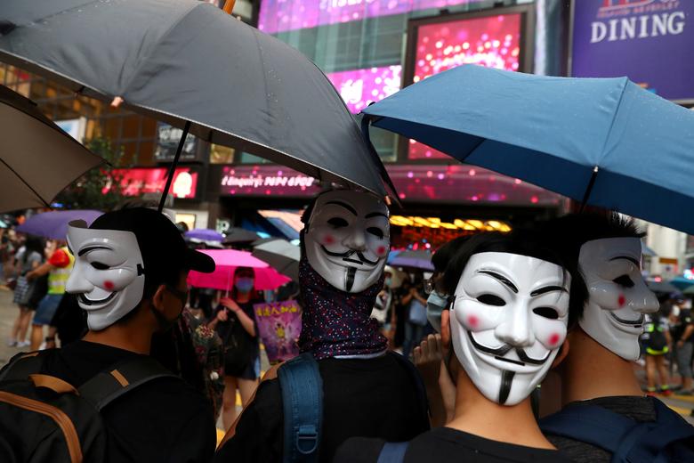 In this file photo taken on Oct 6, anti-government protesters wear masks during a demonstration at Causeway Bay district, in Hong Kong. — Reuters