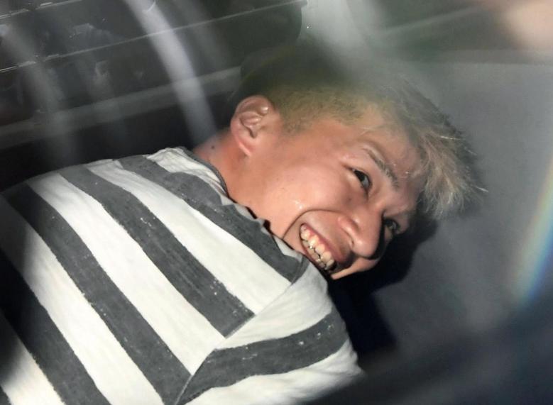 Satoshi Uematsu, suspected of a deadly attack at a facility for the disabled, is seen inside a police car as he is taken to prosecutors, at Tsukui police station in Sagamihara, Kanagawa prefecture, Japan, in this photo taken by Kyodo July 27, 2016. — Reuters