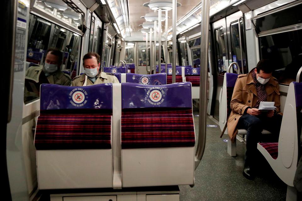 FILE PHOTO: People wearing protective face masks ride the metro in a rush hour in Paris as France softens its strict lockdown rules during the outbreak of the coronavirus disease (Covid-19) in France, May 11, 2020. REUTERSPIX