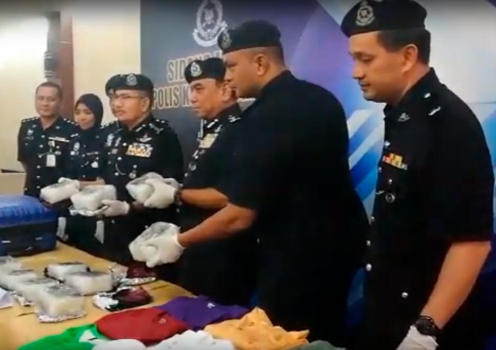 Cops show the drug seized at a press conference today.